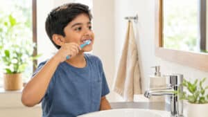 Child brushing teeth to care for a dental space maintainer, Pandit Clinic, Pune